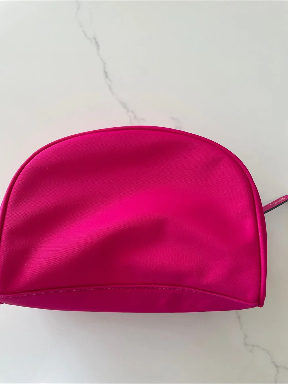 NWOT bright pink Kate Spade zip makeup bag.
